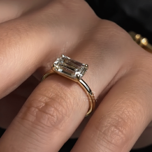 East-west emerald cut solitaire lab diamond ring in yellow gold captured in natural light, symbolizing elegance as a bridal and promise ring gift. Solitaire Engagement Ring in 14k Yellow Gold, Gorgeous Diamond Ring, Handmade Stylish Ring, Gold Anniversary Gifts Ring, Wedding Gift for her, Engagement Ring, Classic Comfort Fit Ring, Handmade Wedding Ring, Emerald Cut Ring, East-West Minimalist Ring, Proposal Ring, Gift For Girlfriend, Statement Ring, Stylish Ring, Promise Bridal Ring, Gift